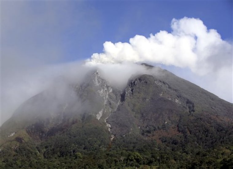 Mount Sinabung spews volcanic smoke as seen from Tanah Karo, North Sumatra, Indonesia, on Thursday.